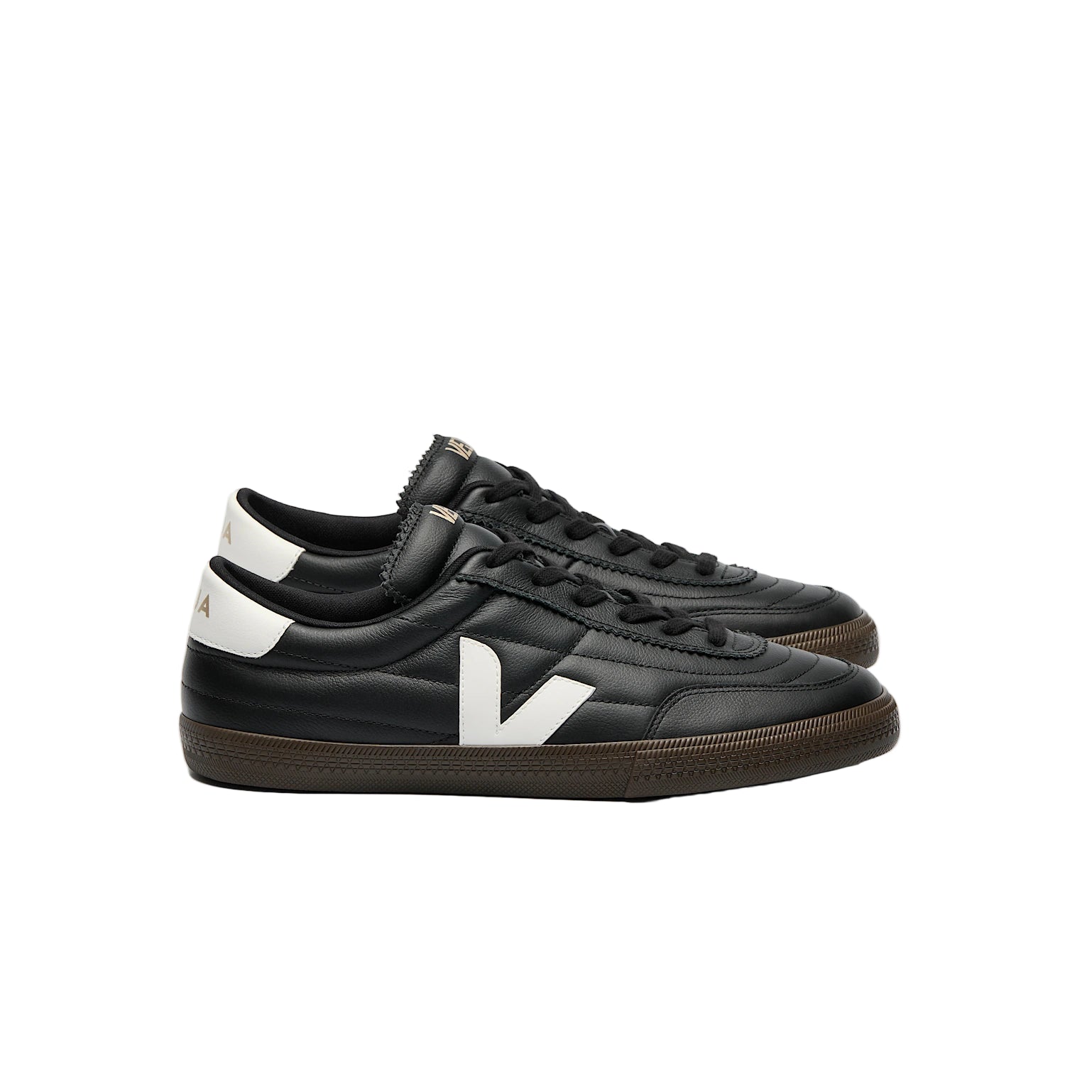 Black sneakers with a white logo on a light gray background