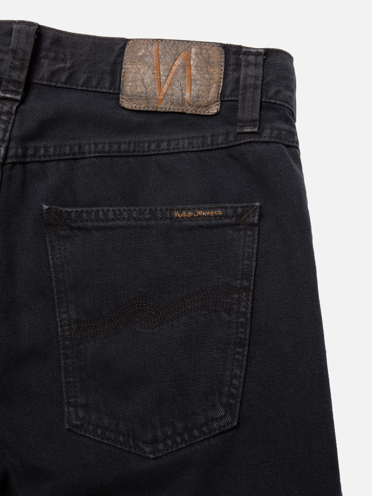 Nudie Jeans Gritty Jackson in Black Forest, close-up of the back pocket with signature stitching and jacron patch.