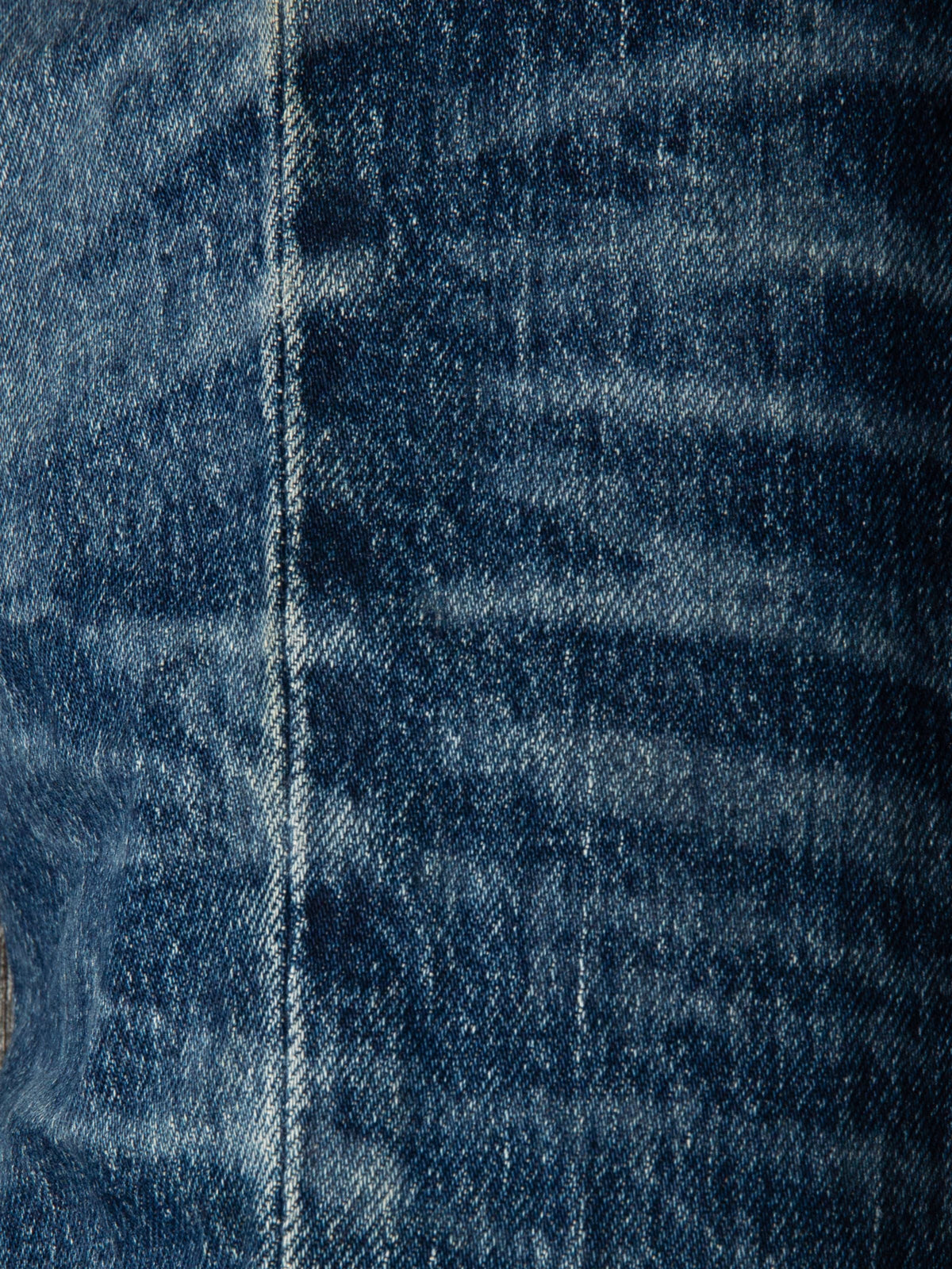 Nudie Jeans Solid Ollie Life Tracks, a close-up of the dark blue stretch denim showcasing the faded wash and texture.