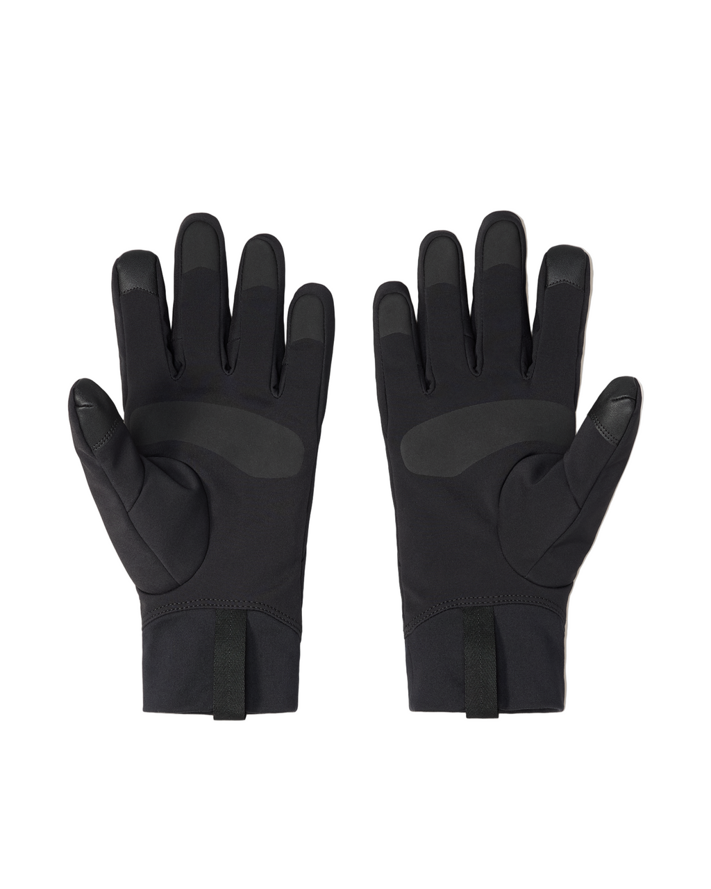 Pair of black gloves on a light beige background