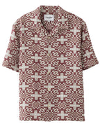 A short-sleeved camp collar shirt with a geometric pattern in brown and white colors.