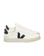 White sneakers with black accents and 'Veja' branding on a white background