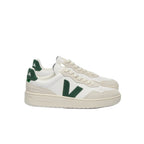 White sneakers with green accents on a white background